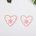 Red heart shaped fiberboard Christmas ornament with a printed design