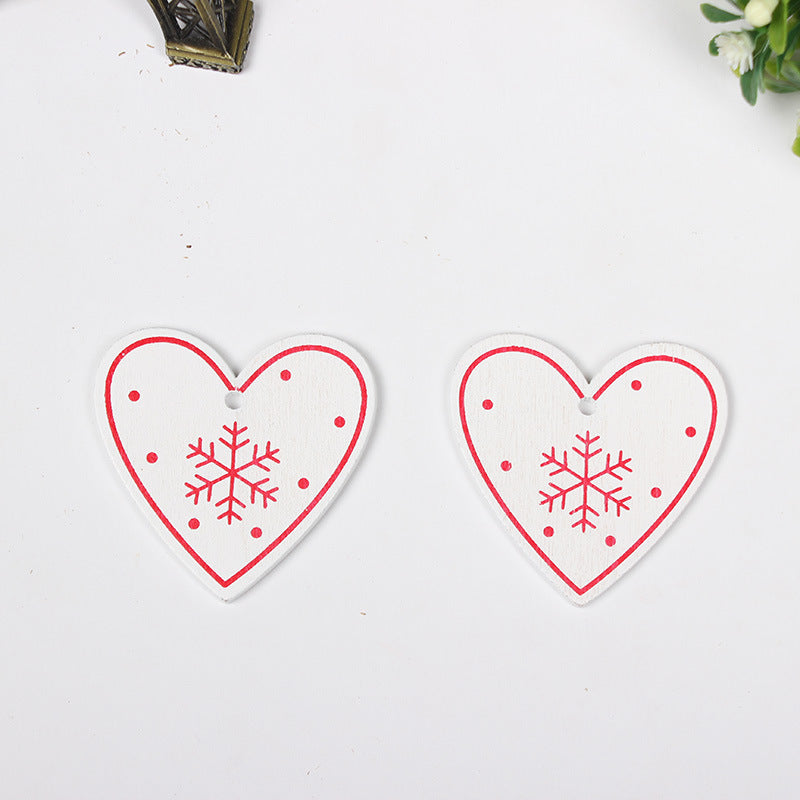 Red heart shaped fiberboard Christmas ornament with a printed design