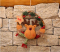 Snowman figure set into a small woven vine Christmas wreath