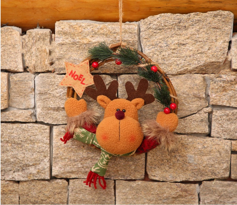 Snowman figure set into a small woven vine Christmas wreath