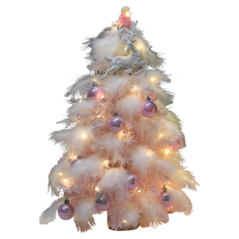 Pink feather branches spreading light on the mini Christmas tree