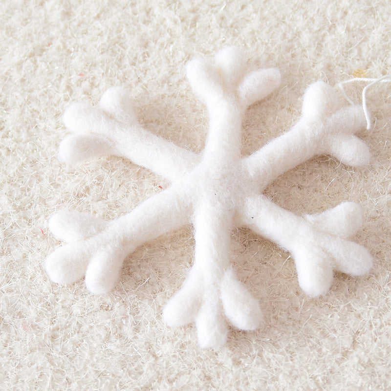 White wool felt snowflake Christmas ornament measuring 7.5 inches across