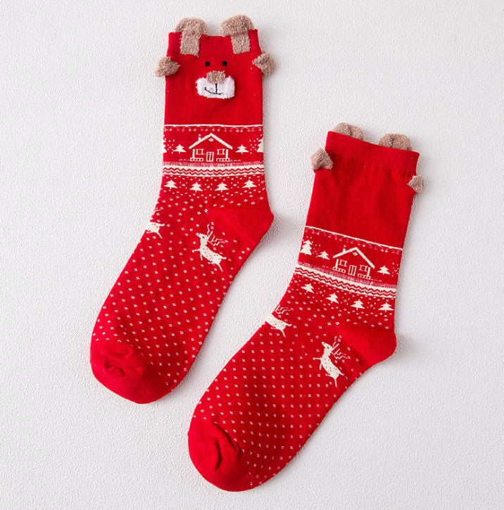 Red reindeer Christmas socks knitted at a standard winter thickness