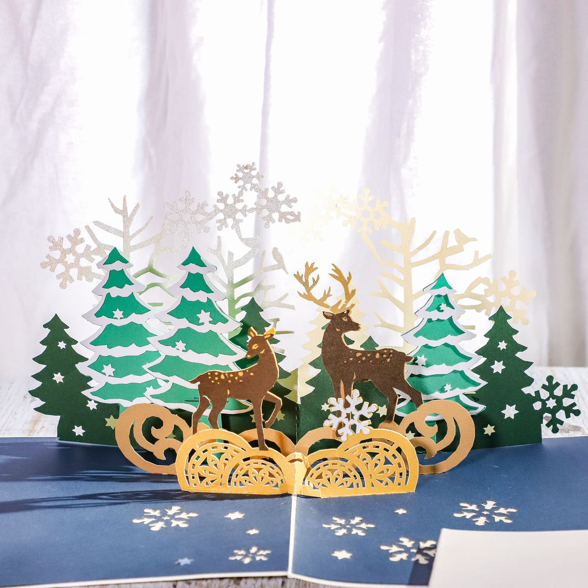 Handmade Christmas greeting card cut from special craft paper with a reindeer motif
