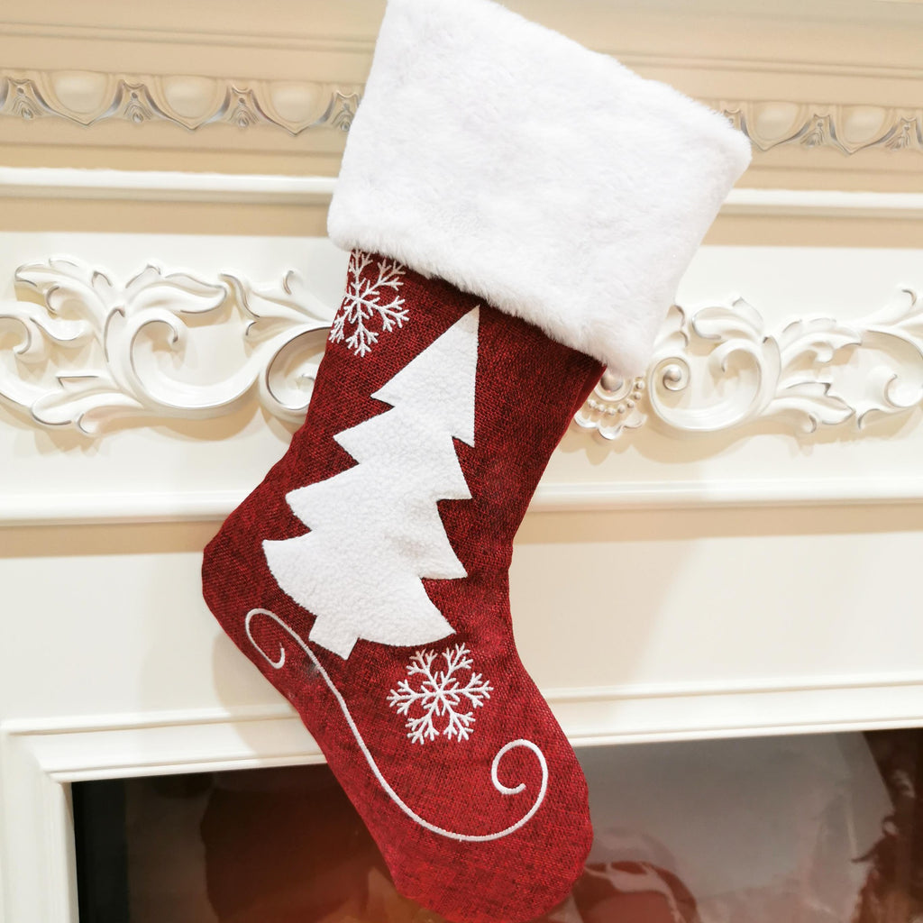 Four Christmas stocking designs: snowflake, small deer, large deer and tree