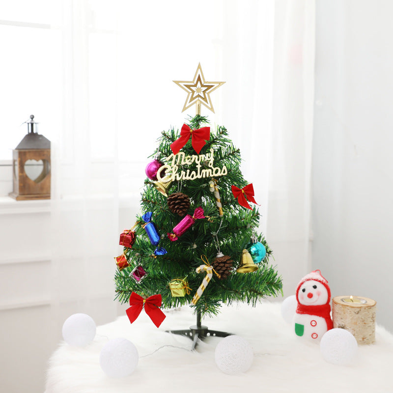 Tabletop Christmas tree with green PVC branches spread in a full cone