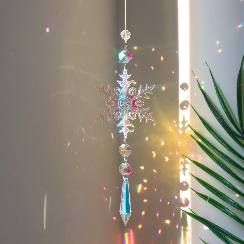Beaded acrylic snowflake ornament ready to hang from a branch