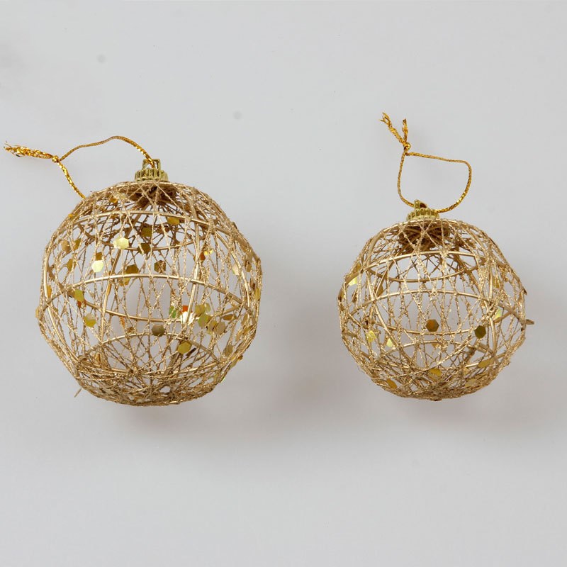 Scaled gold dusted surface on one iron Christmas bauble
