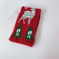 Close knit acrylic yarn with embroidered Christmas stitching on the scarf