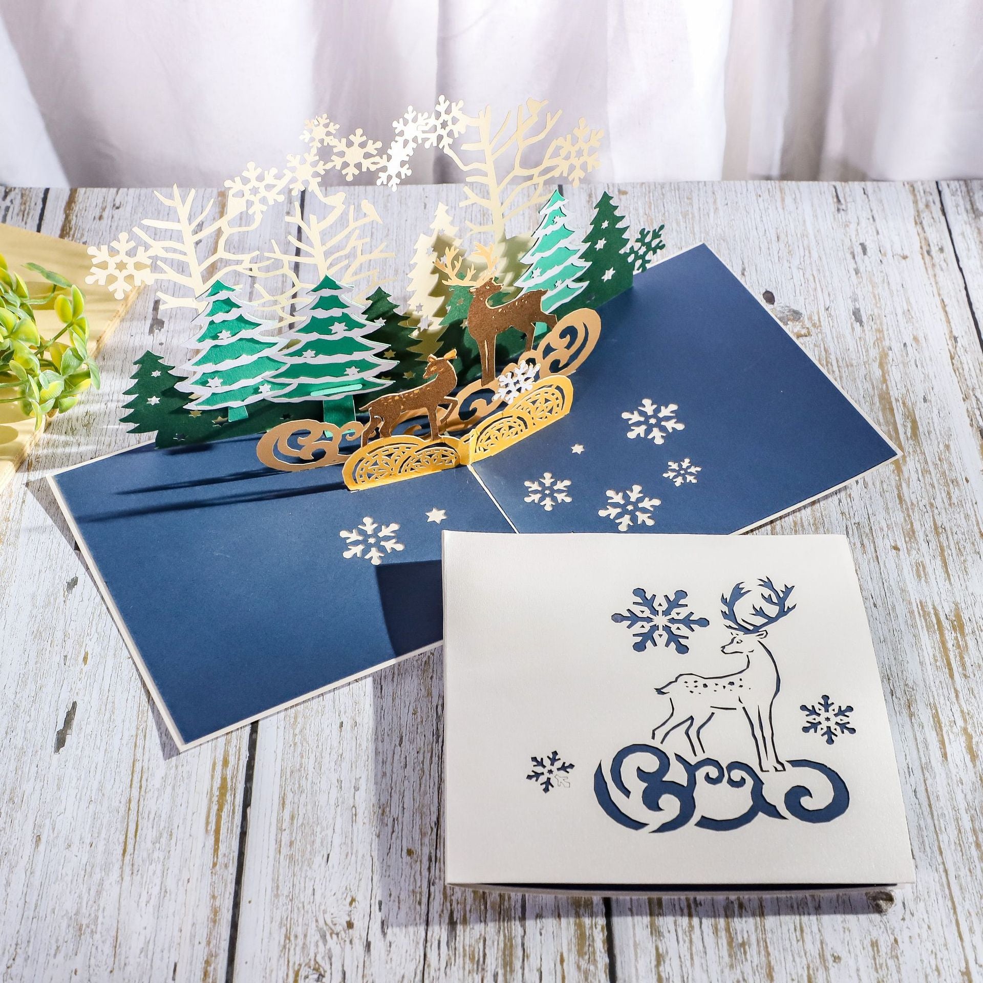 Christmas reindeer card assembled manually rather than machine folded