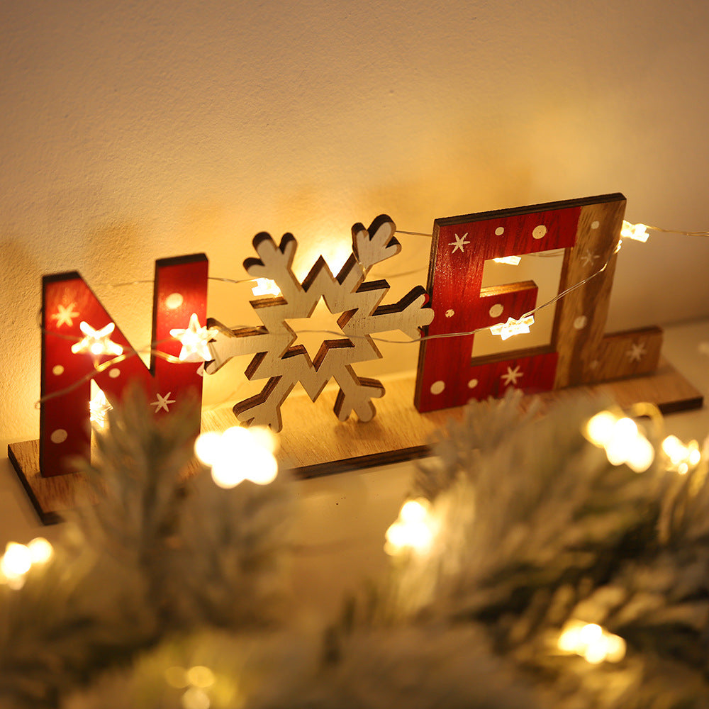 Wooden hanging sign reading Xmas in printed color over grain