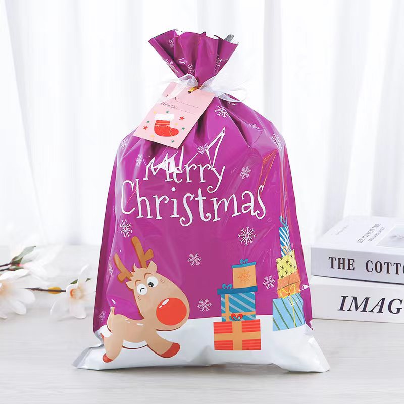 Small foil Christmas treat bag pulled shut by its drawstring cord