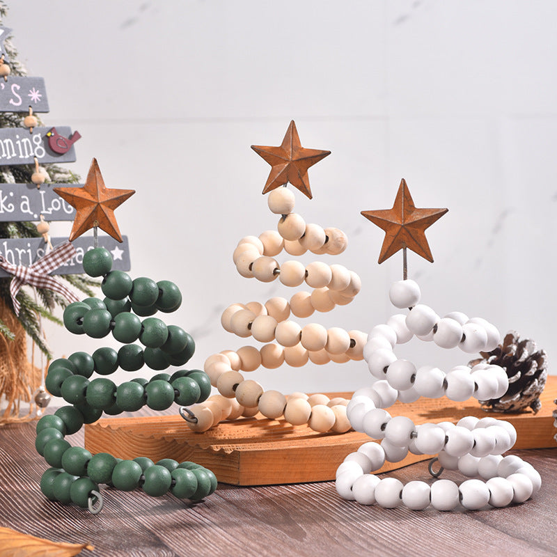 White wooden Christmas decoration on a wrought iron frame