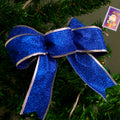 Red ribbon Christmas bow with a light-catching glitter face