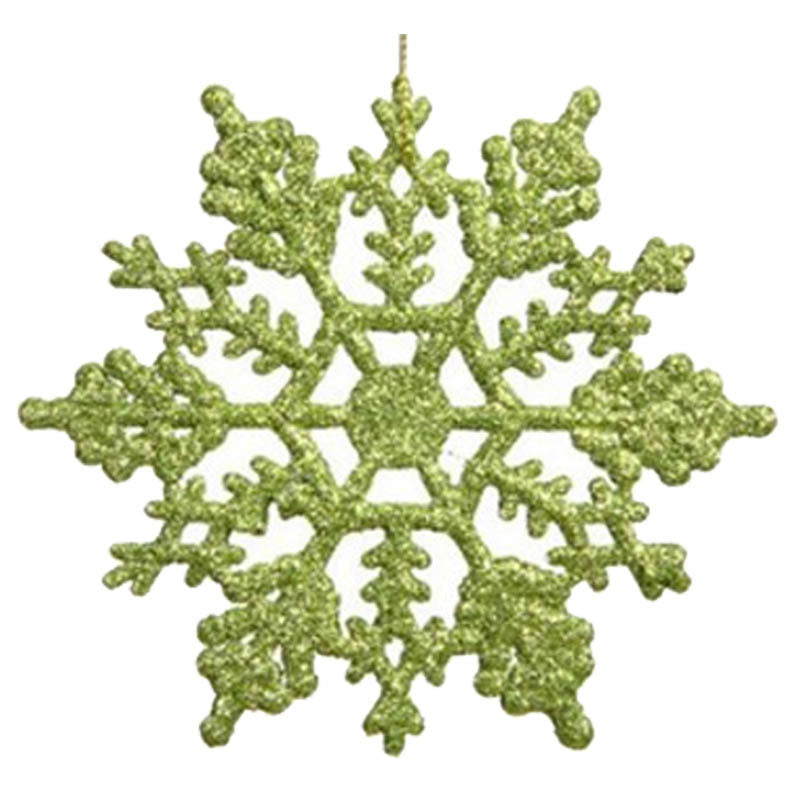 Green Christmas snowflake ornament ready to hang from a branch