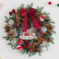 Christmas wreath trimmed with pine cones, bows and baubles in molded greenery