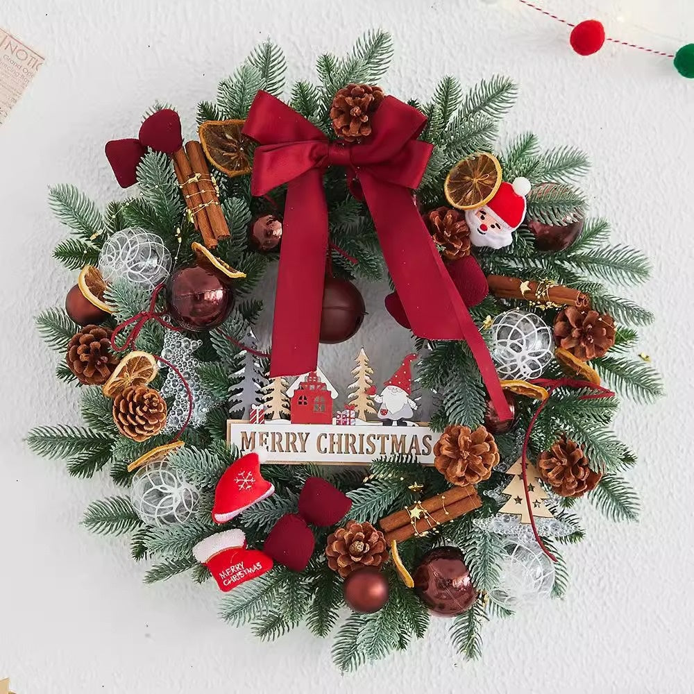 Christmas wreath trimmed with pine cones, bows and baubles in molded greenery