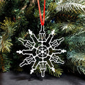 Boxwood snowflake Christmas ornament in a natural wood finish, 4.3 inches across