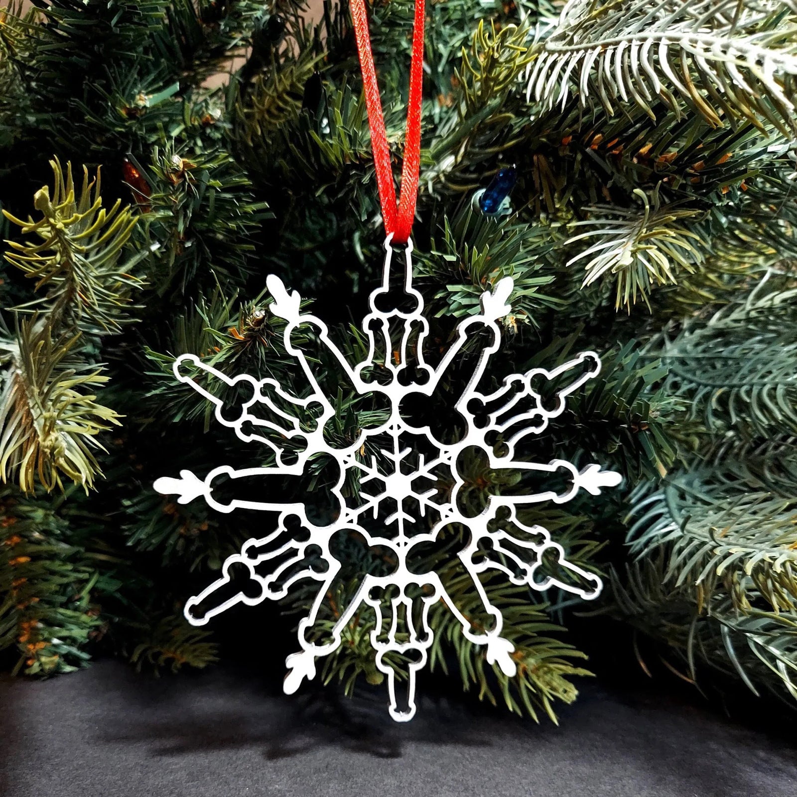Boxwood snowflake Christmas ornament in a natural wood finish, 4.3 inches across