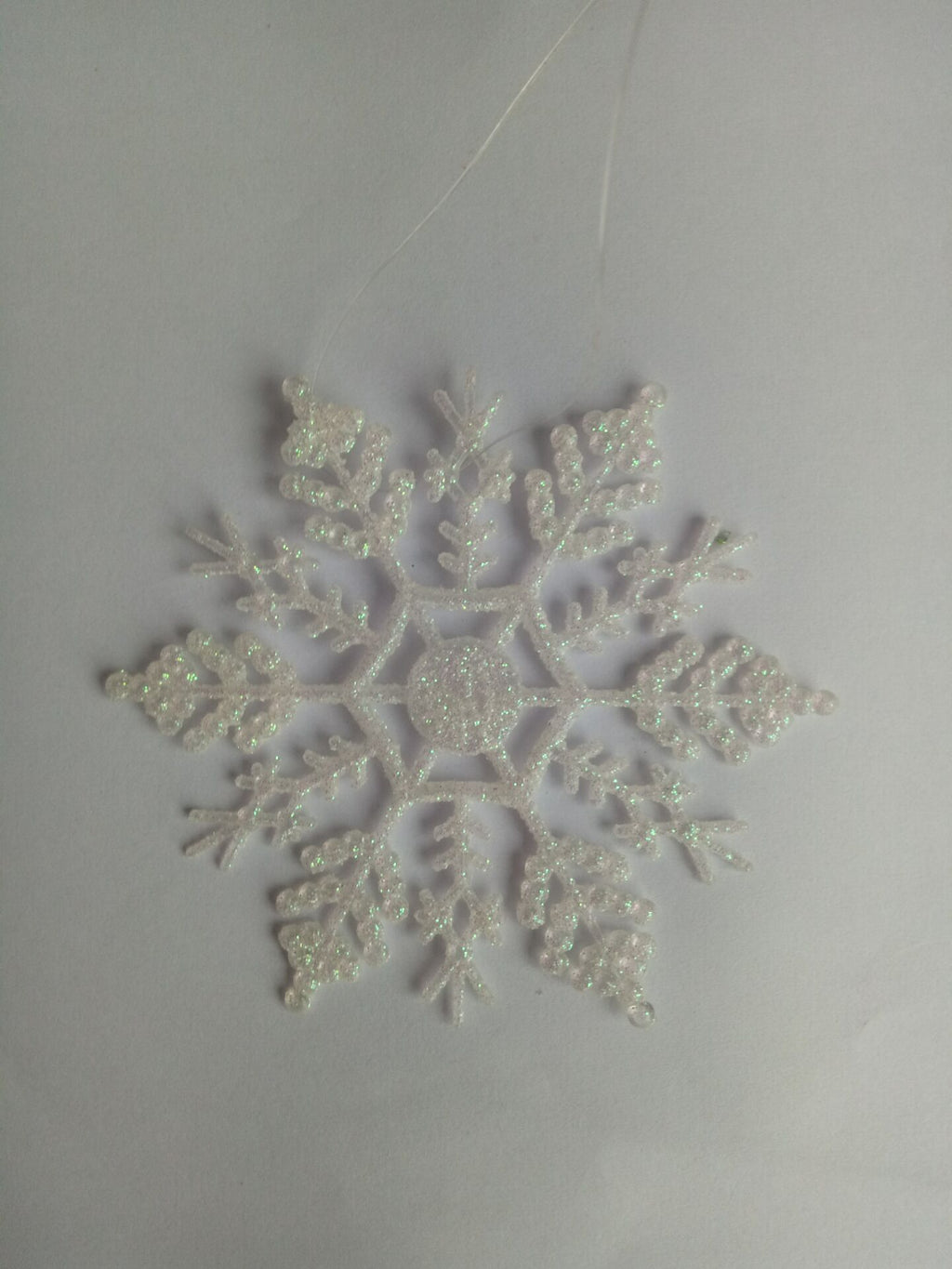 Twelve acrylic snowflake ornaments make up one complete pack