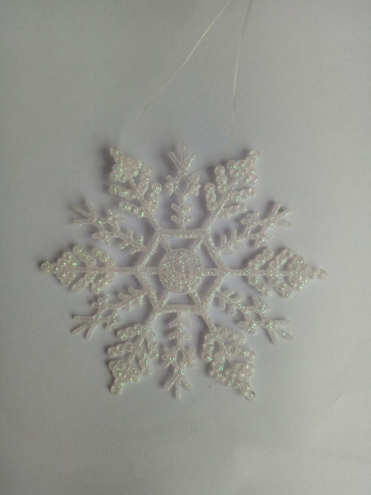 Twelve acrylic snowflake ornaments make up one complete pack