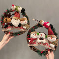 Natural rattan Christmas wreath trimmed with Santa, a snowman and a reindeer