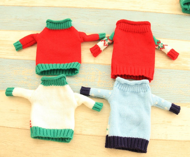 Joy, tree, reindeer and snowman knitted Christmas bottle covers together