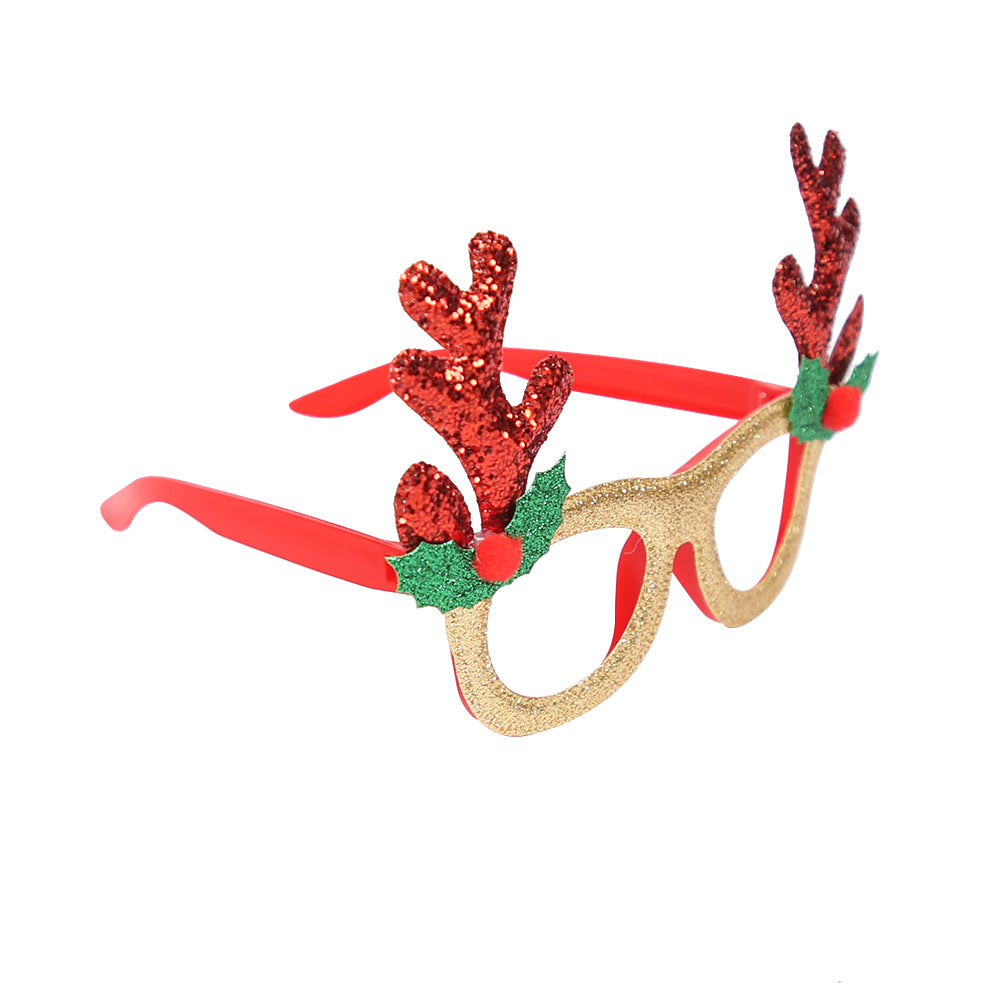 Red framed party glasses topped with long green antlers, lens free