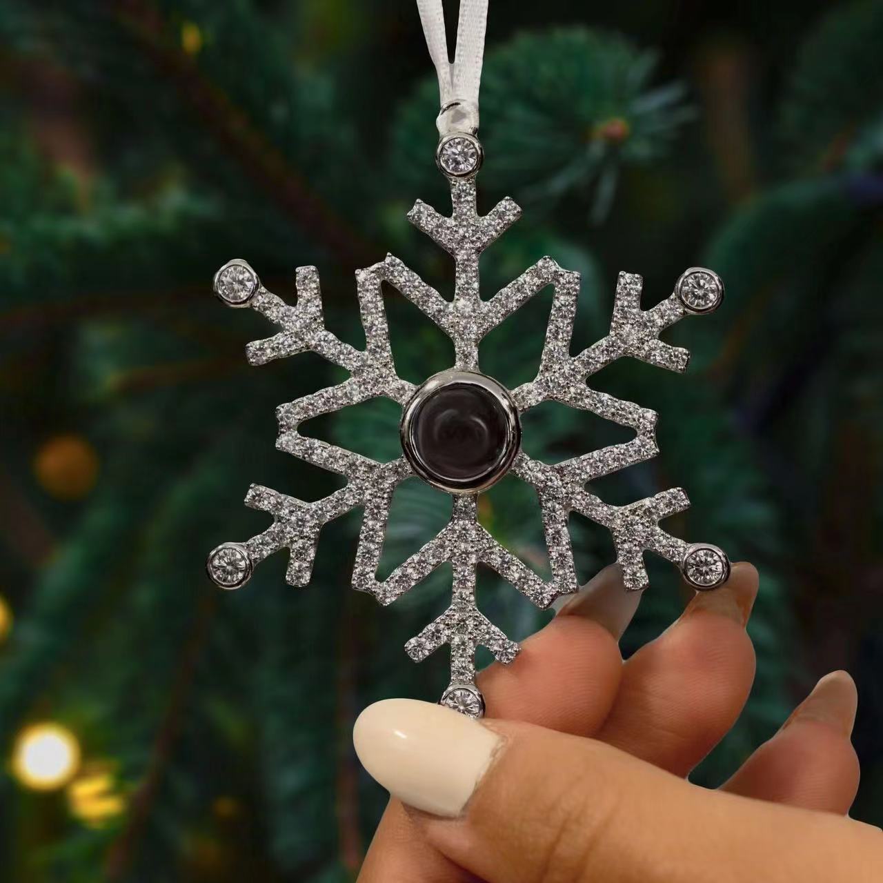 Electroplated snowflake pendant with cut facets across the alloy body