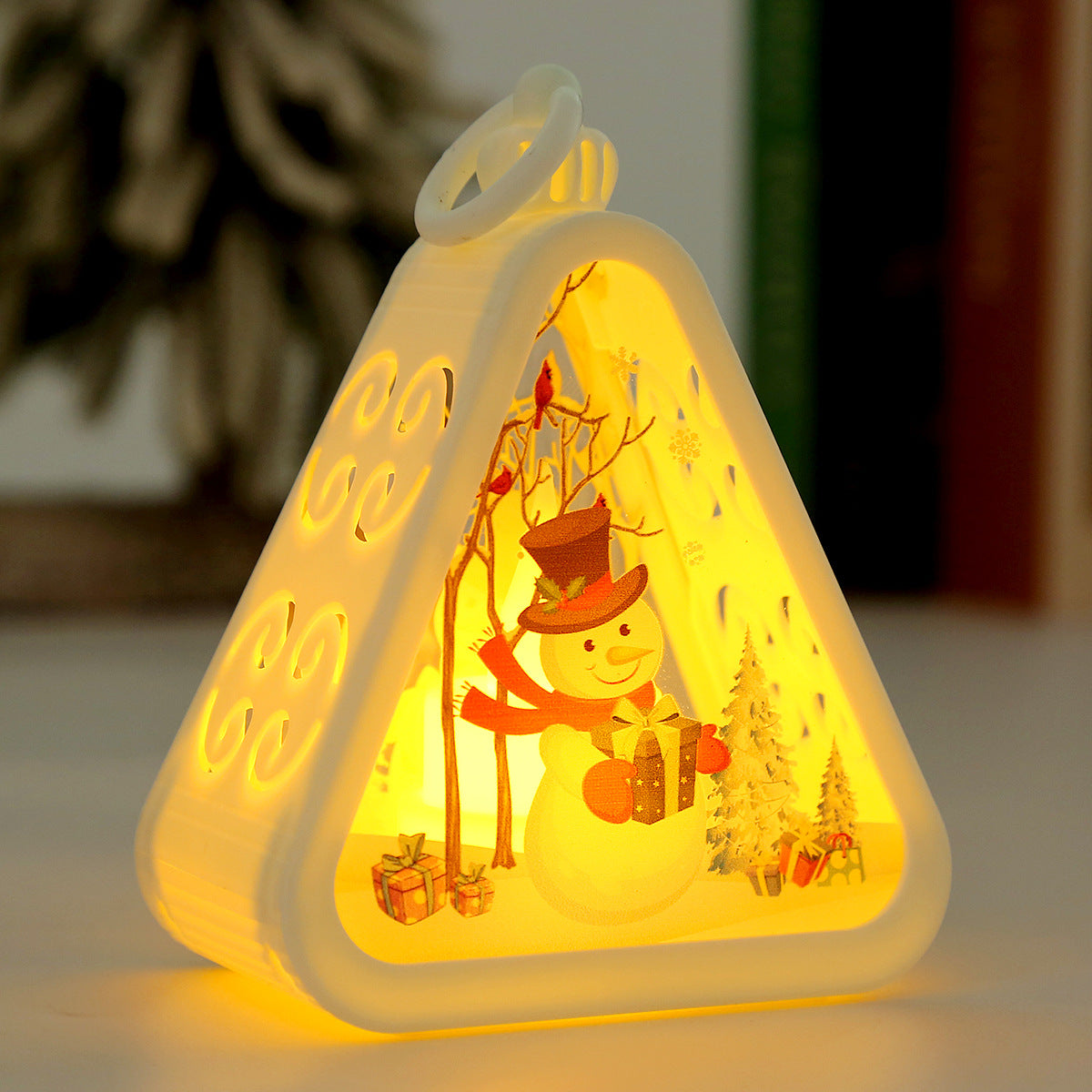 Triangular red Christmas lamp with a reindeer figure inside