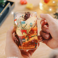 Molded snowman shaping forms the body of this clear glass holiday mug