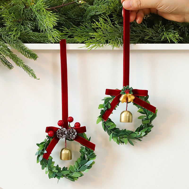 Christmas bell garland molded from PVC with pine cones, berries and green leaves