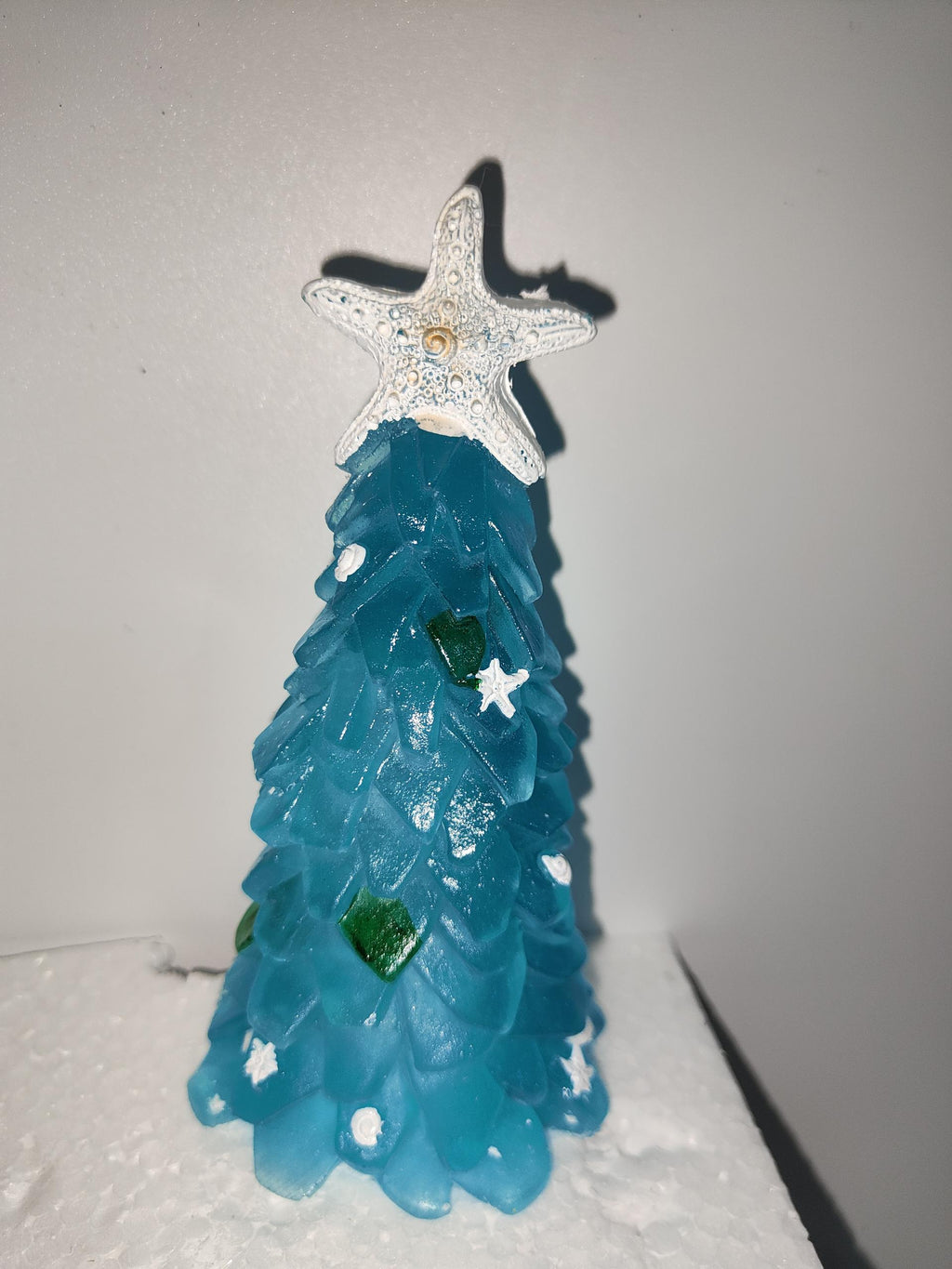 Undecorated blue tabletop Christmas tree ready to trim with shells or beads