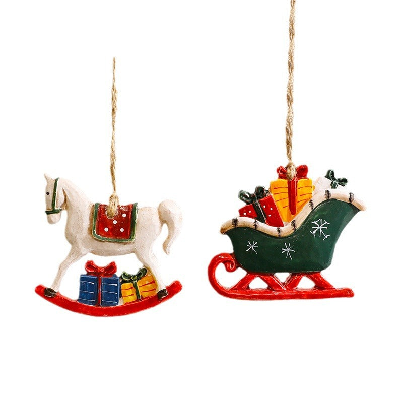 Resin Santa's cottage ornament with a snow covered roof