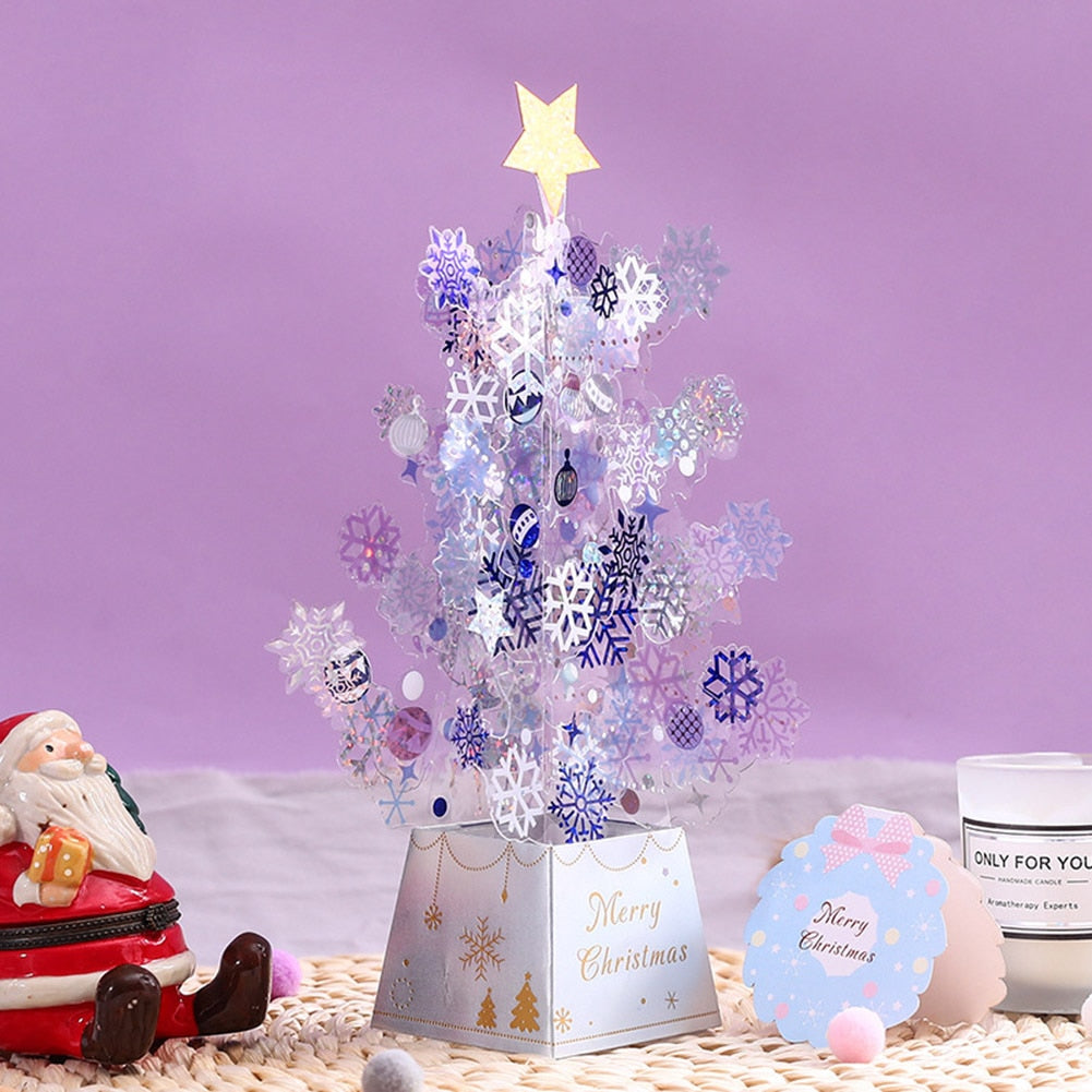 Clear snowflake sequins scattered across the paper Christmas tree