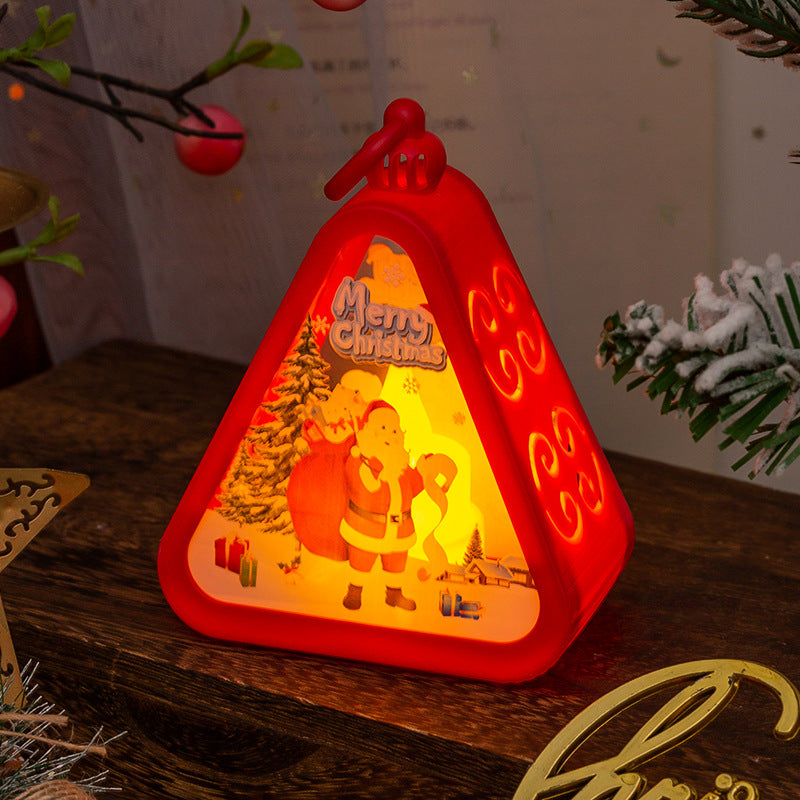 Triangular bronze night light with a snowman figure inside the glass