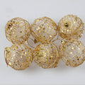 Gold Christmas ball ornament, 2 inches across, for hanging on a tree