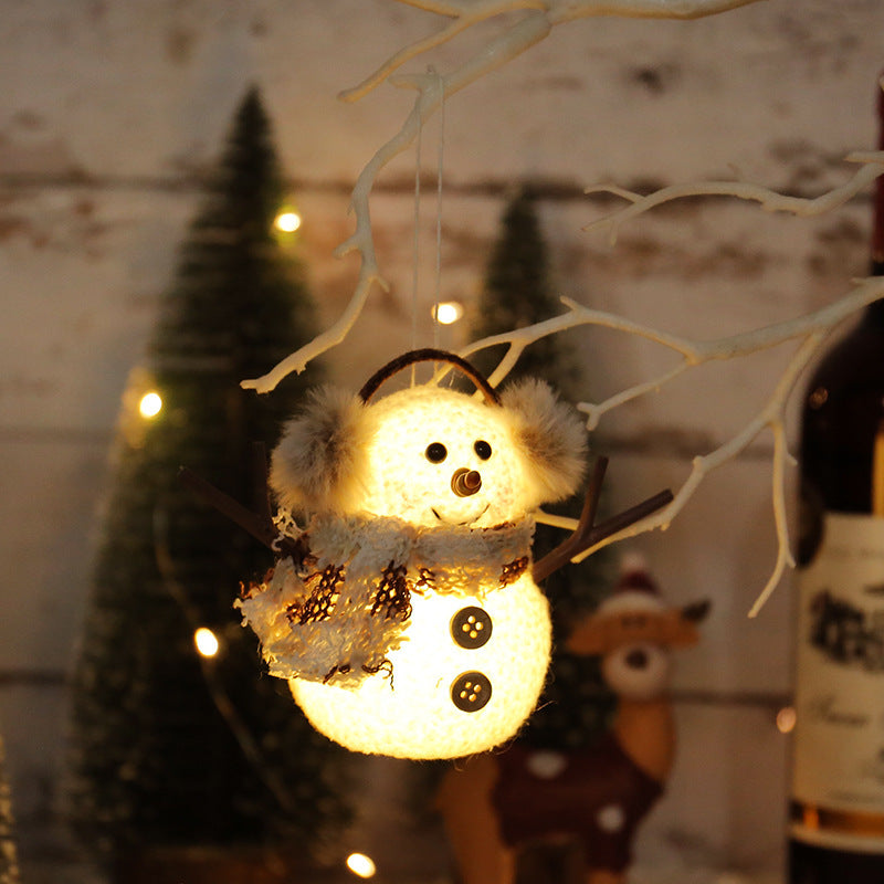 Two snowman figures, one with a plaid scarf and one striped