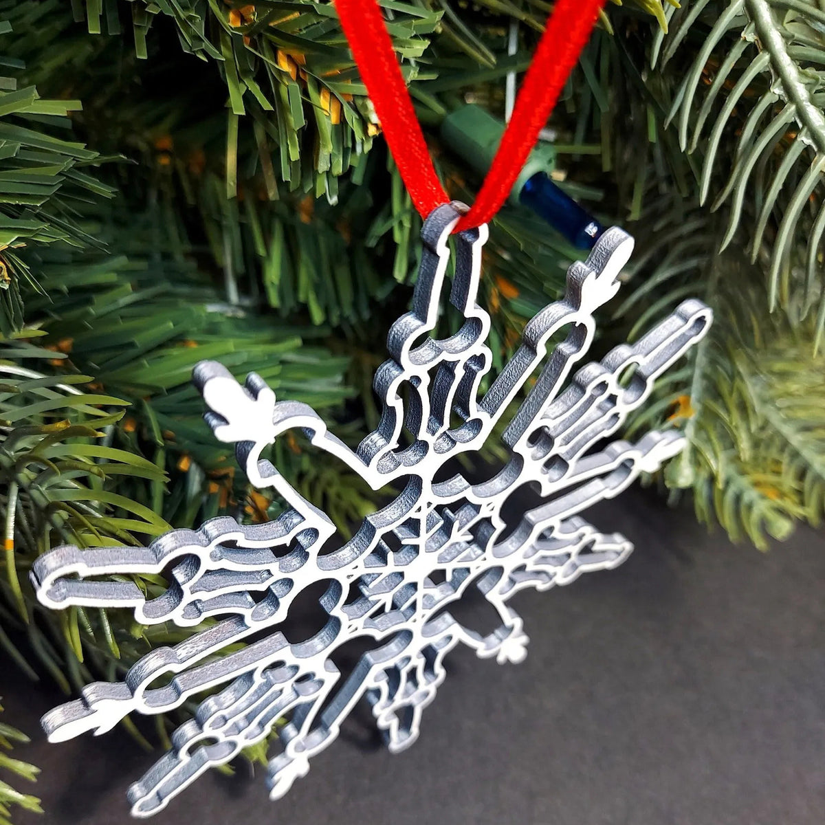 Wooden Christmas snowflake pendant showing the natural grain of solid boxwood