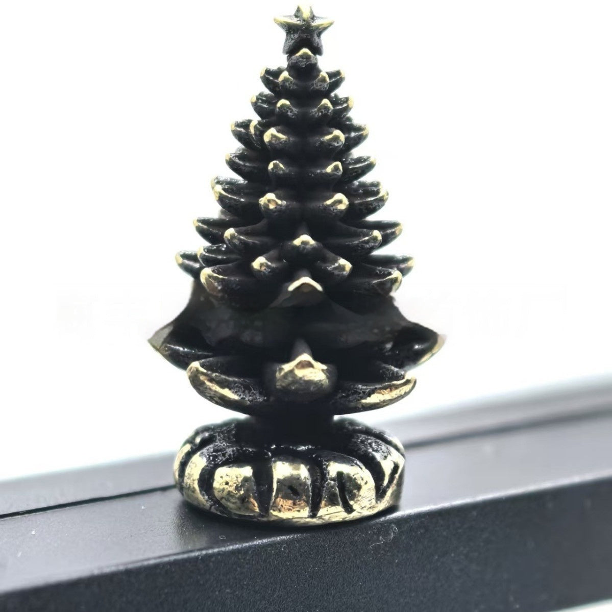 Christmas tree shaped metal ornament with a hinged center joint