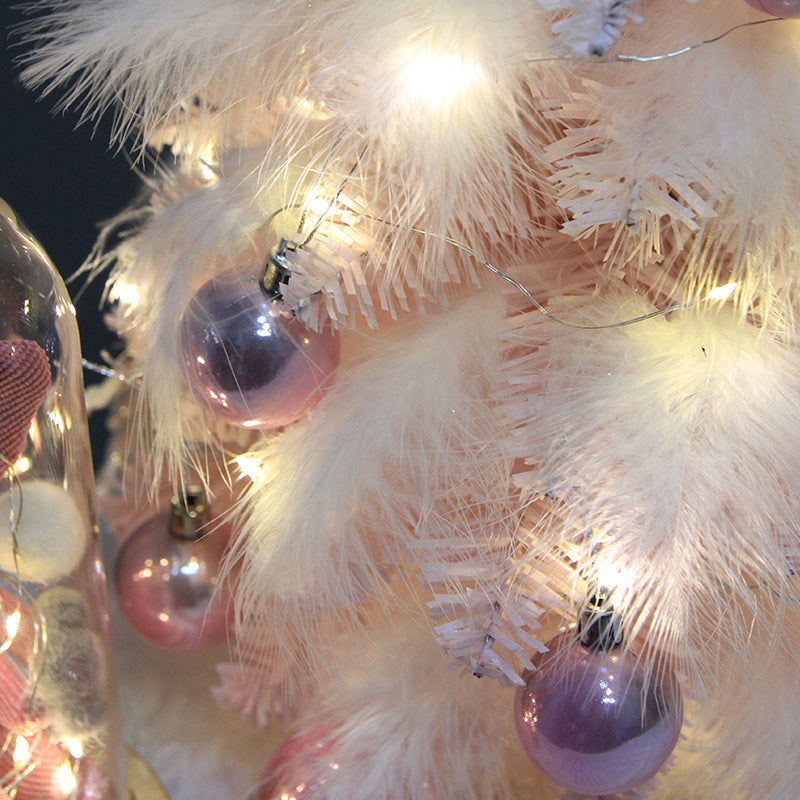 Mini Christmas tree with LED lighting set inside the feather branches