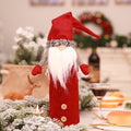 Faceless doll bottle cover with an open base that pulls over a bottle