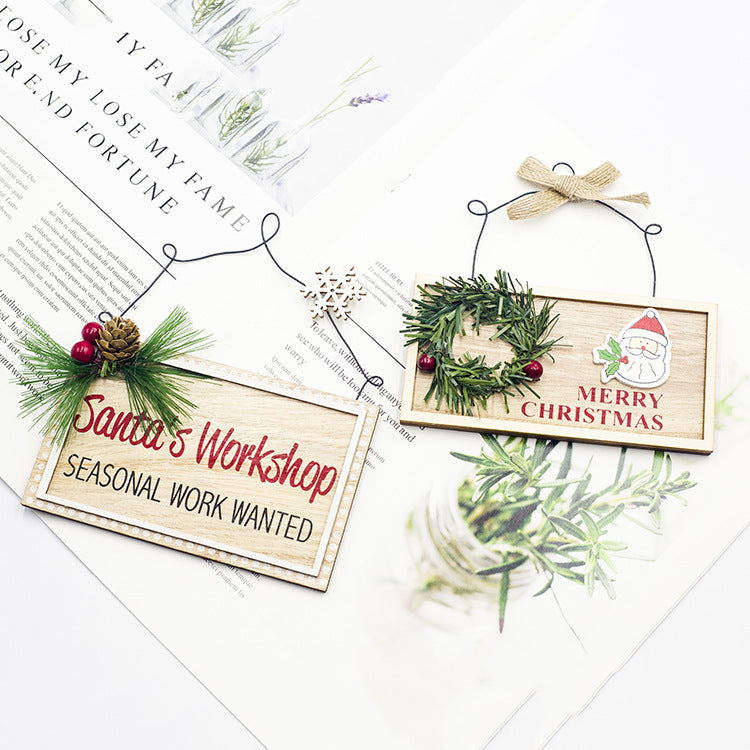 Painted wooden Christmas plaque carrying the pine cone design