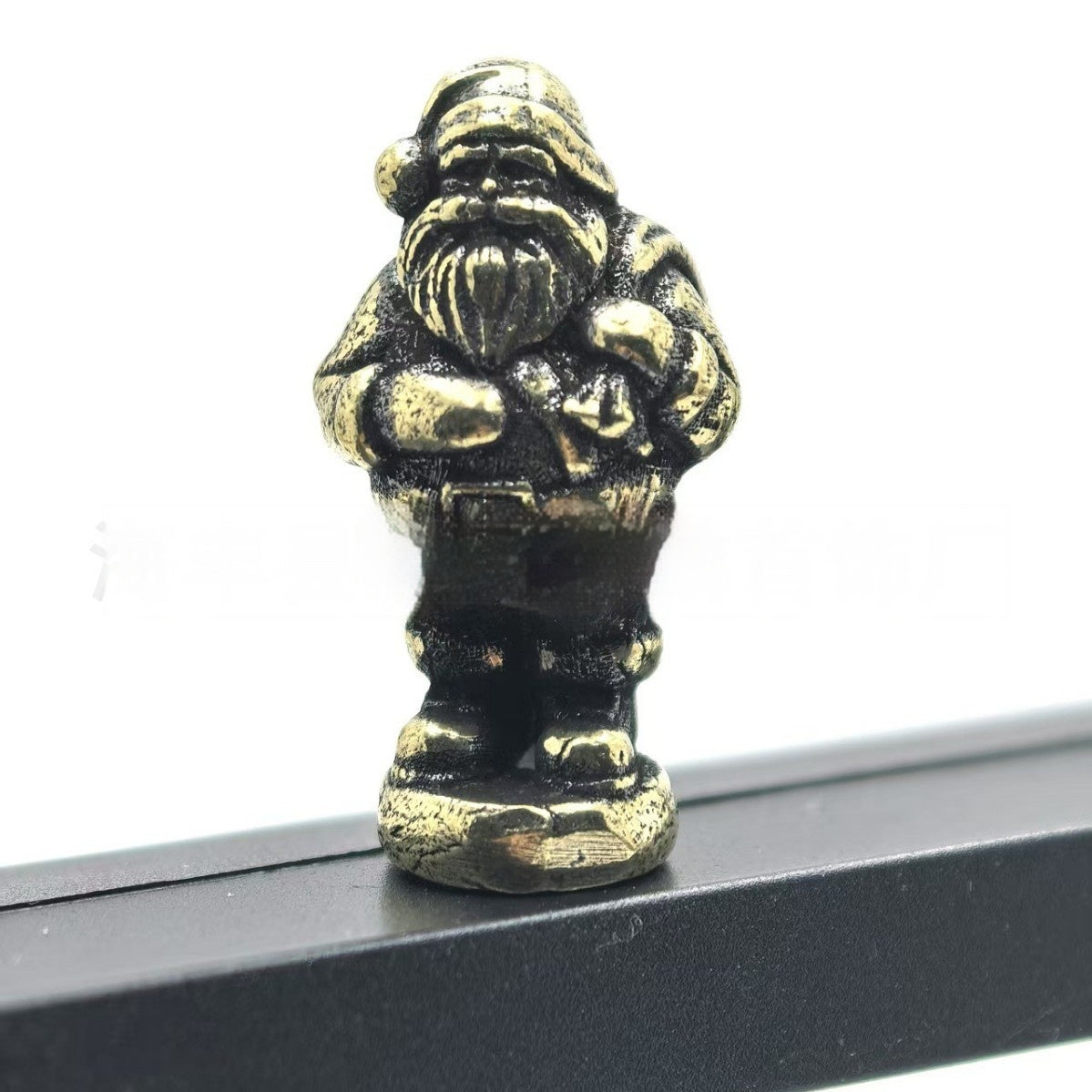 Metal gnome Christmas tree ornament with a hinge at the middle