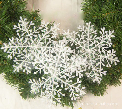 Single 4.3 inch plastic snowflake with a cut-out pattern