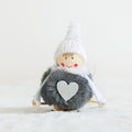 Soft plush pile and the stitched hanging loop of the pendant