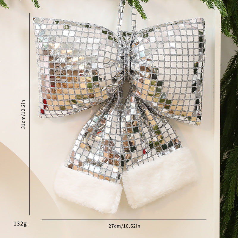 Mirrored sequins covering the cloth body of the Christmas tree bow