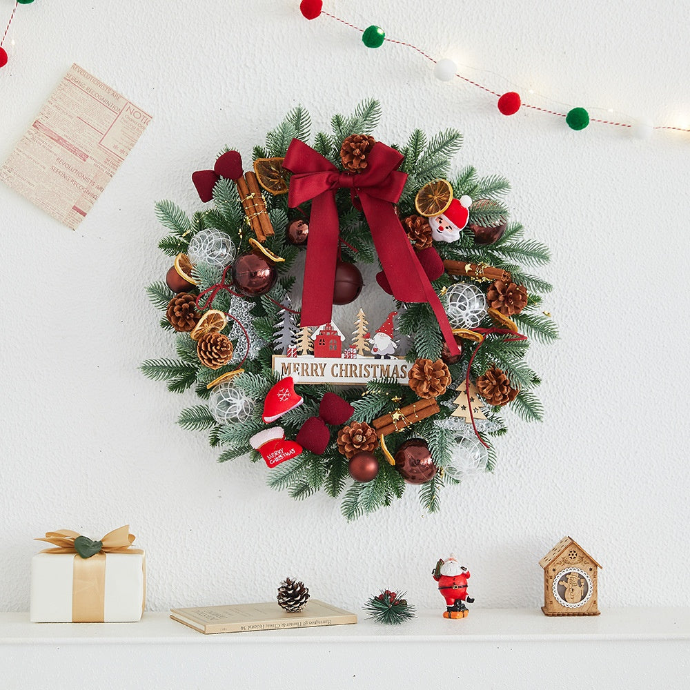 Pine cone, bow and bauble trims worked into a polyethylene Christmas wreath
