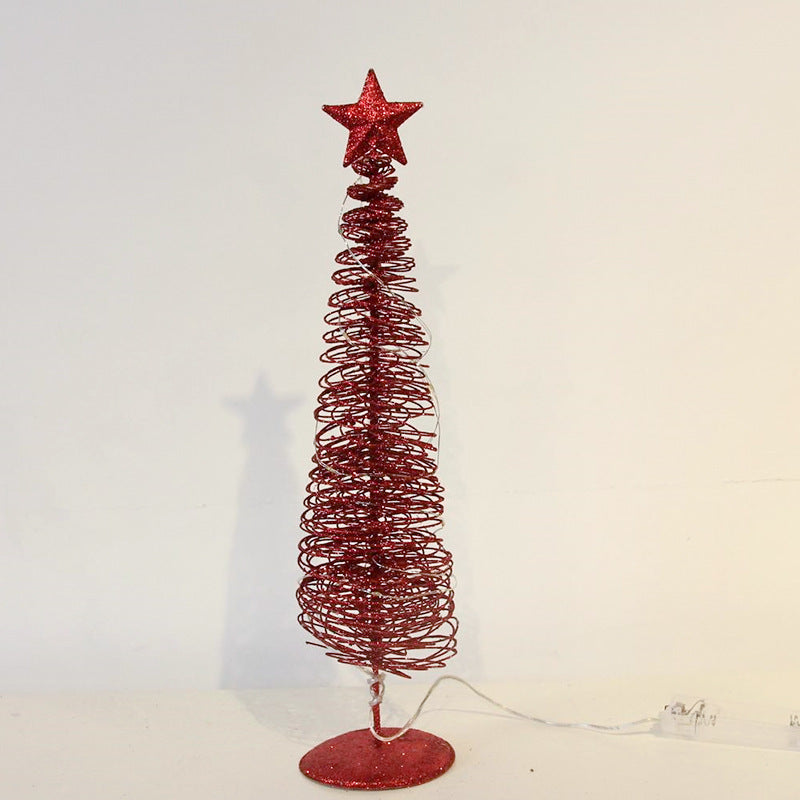 Bent iron frame giving the small Christmas tree a crisp outline