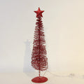 Bent iron frame giving the small Christmas tree a crisp outline